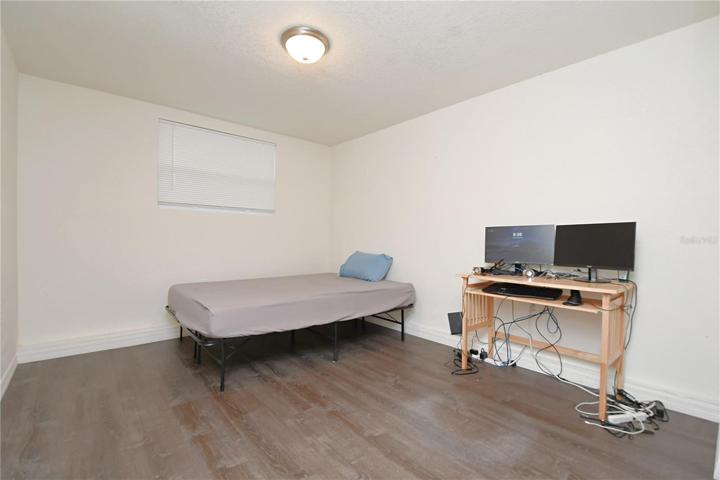 Bedroom #4 featuring luxury vinyl flooring.