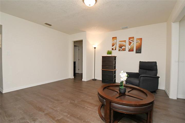 Another view of a living room with luxury vinyl flooring.