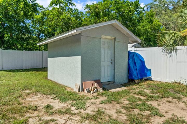 Concrete / Stucco Shed in Fenced Backyard