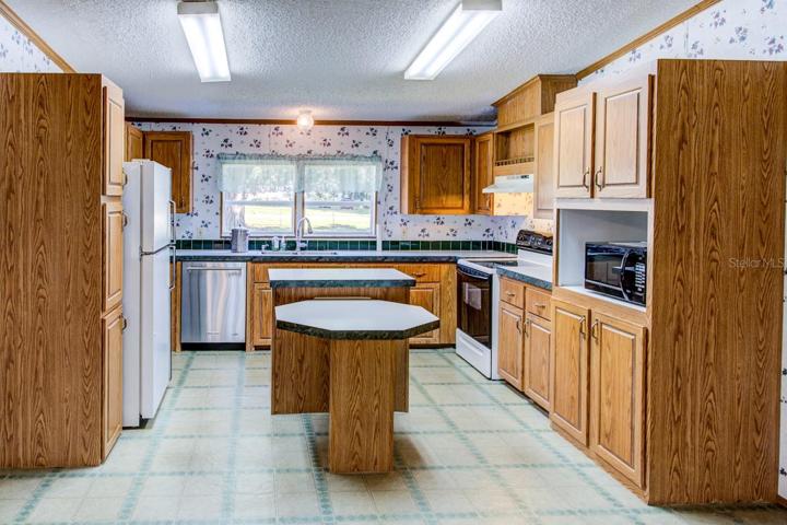 Real wood cabinets in the Kitchen area.