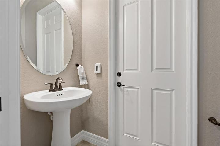 HALF BATHROOM WITH DOOR GIVING ACCESS TO OUT BACK ~ PERFECT FOR A POOL BATH!