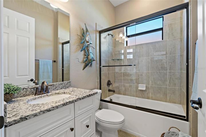 GUEST BATHROOM WITH SHOWER/TUB COMBO AND GLASS FRAMED SHOWER!