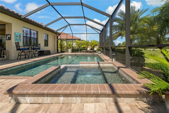 BEAUTIFULLY DONE PEBBLE TEC POOL AND SPILL OVER SPA!