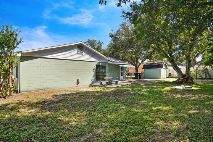 Outside, the expansive backyard offers endless possibilities for outdoor activities and is the perfect blank canvas to create the outdoor space of your dreams bordered by mature trees for shade and privacy!