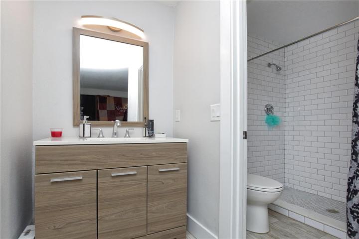 The bathroom has been remodeled and has a tiled shower.