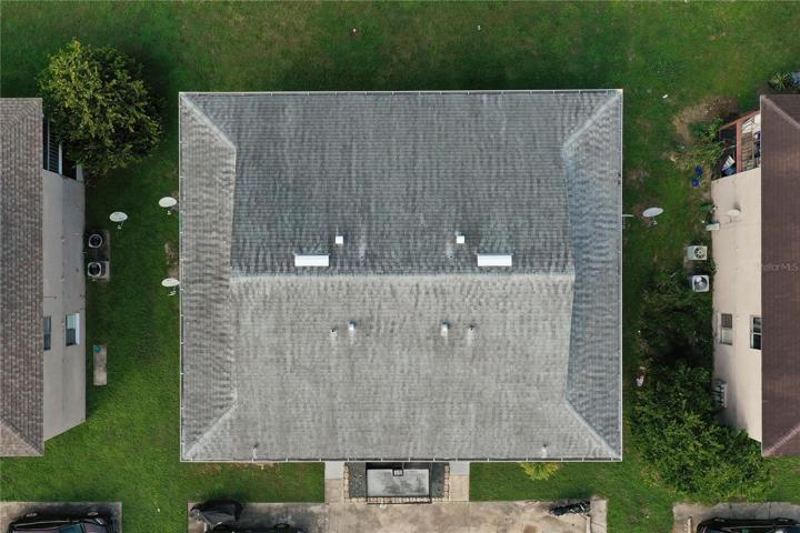 The aerial view of the property with a 2016 roof and gutters.