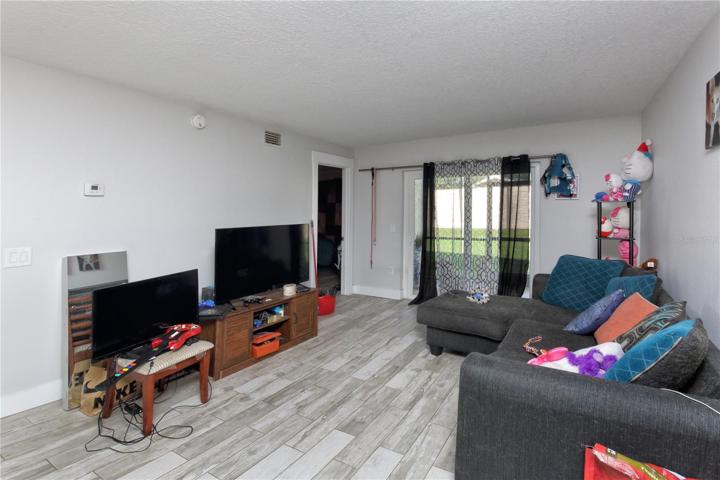 The dining room/living room layout gives an open feel.  The sliding glass doors lead out to the screened in patio and out to the back yard.
