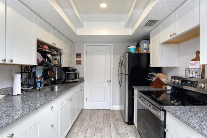 The kitchen has been remodeled with granite counter tops, new cabinets, stainless steel appliances, new paint, and tile floors.