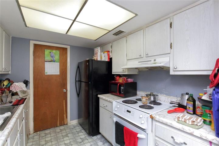 The kitchen of the unit that has not been remodeled.