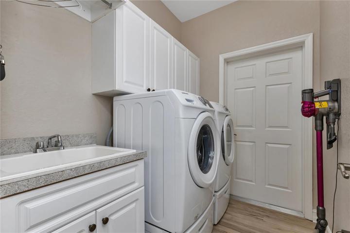 Inside laundry room with sink & cabinets -lots of storage