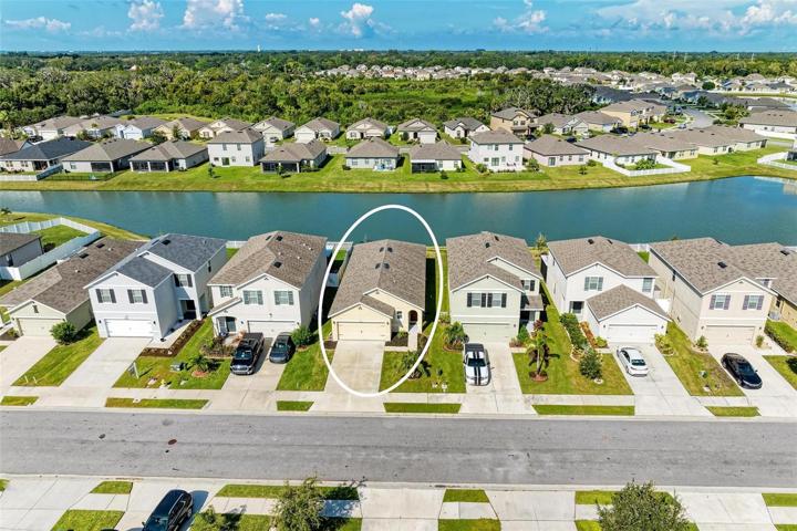 Aerial view of home and pond beyond