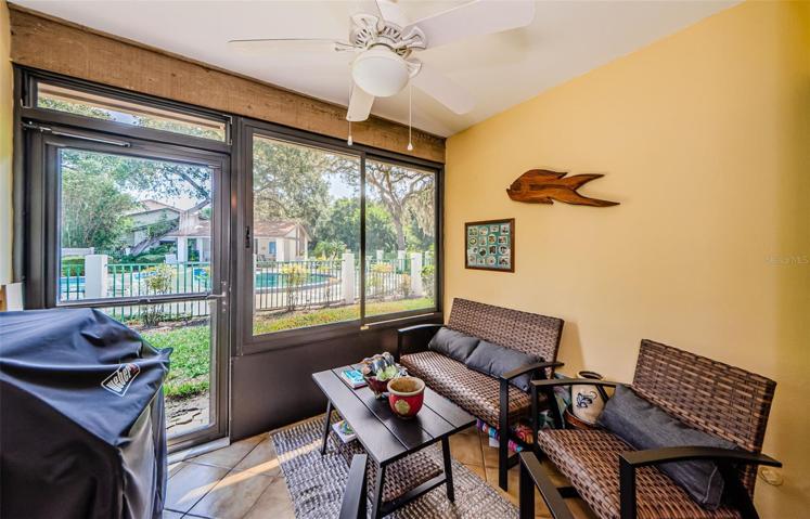 Enclosed Florida room overlooking the community pool
