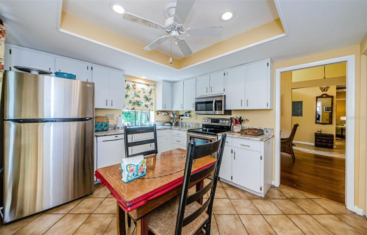 Eat in kitchen with tile floor and newer appliances