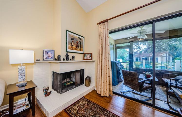 Fireplace in living room with sliders leading to Florida room