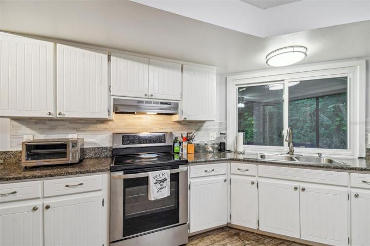 Granite counters with stone backsplash.