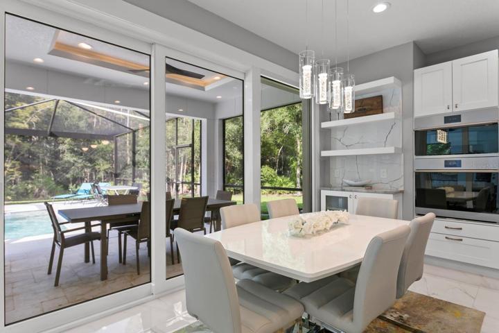 Casual dining area in kitchen with backyard views