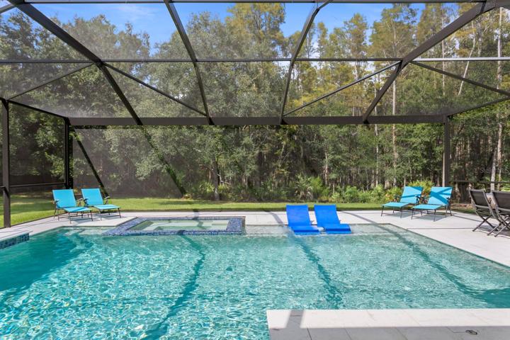 Super-screen lanai design provides unobstructed views of the woods behind the home
