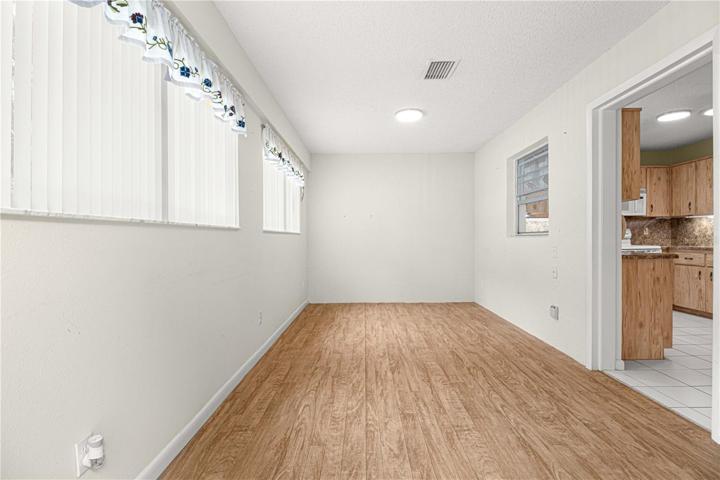 Florida Room with level floor with kitchen & LOTS of windows!