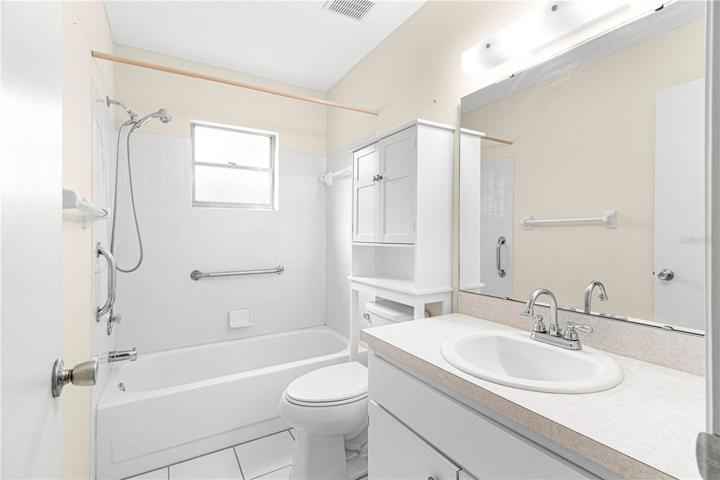 Hall/Guest Bath with Tub and Tile Surround - Comfort Height Toilet