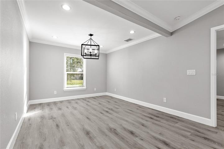 Dining area - If you have a large dining room table/buffet table etc, then this is perfect - oversized and part of the open floor plan concept - check out the beautiful trimwork and crown molding - this is a buidler who takes pride in their product and it is easy to see the difference between an 