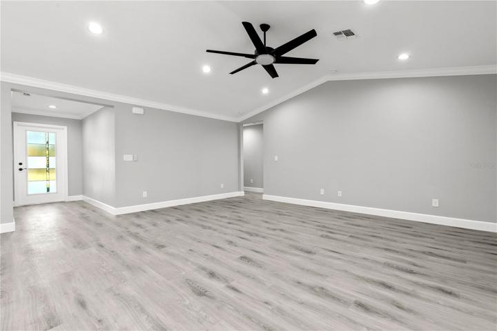 WELCOME HOME!  This large great room has soaring vaulted ceilings, recessed lighting, beautiful LVP floors, lots of natural light and is open to both the dining and the kitchen - a 'GREAT