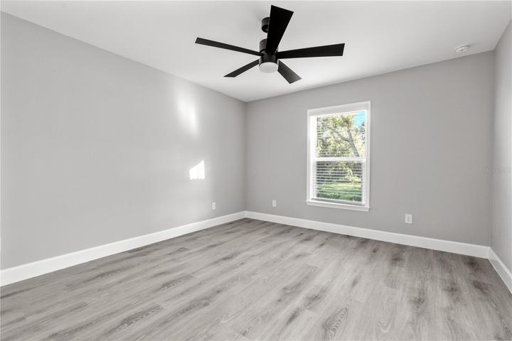 Guest room 1 - one of three spacious bedrooms, all with LVP flooring, upgraded ceiling fans, window blinds already installed!