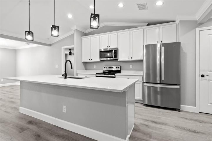 GOURMET kitchen!  Large island to gatther around,  beautiful surfaces throughout the entire home, 42 inch shaker cabinets, stainless steel appliances, upgraded lighting - if you like to cook this is the perfect kitchen with lots of character and charm!  Walk in pantry has plenty of room for food and storage!