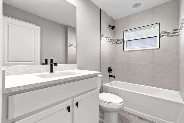 Guest Bathroom is the same quality you will see in the master bath - shaker cabinets, custom tile accents and plenty of storage!