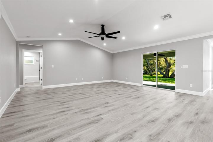 Living area - double sliders lead to the outdoor patio with screened in picture window!  The views are as spectacular as the inside of the home - an extension of the indoor and outdoor living areas to live your best life and enjoy the weather year round that SWFL is known for!