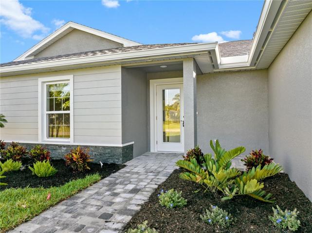 Stone veneer accents, beautiful pavers, gorgeous landscaping!  Decorative stucco - this home is full of character both inside and out!