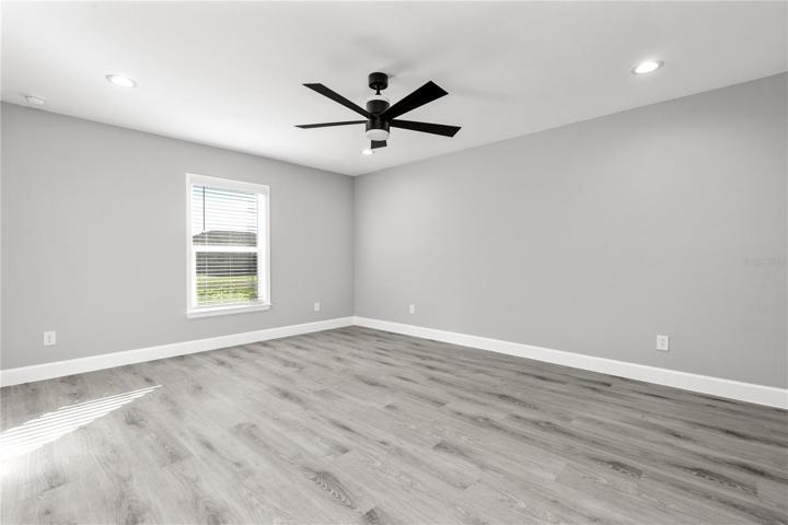 The master bedroom is split from the other three bedrooms for privacy - not only large and spacious, but also has the natural light that is abundant throughout the home.  All blinds and ceiling fans are included and installed - move right in!