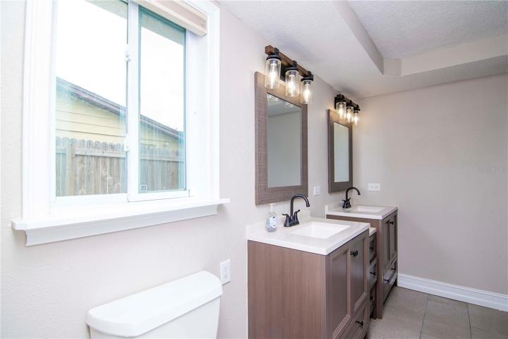 Master Bathroom with dual vanity sinks and shower/tub combo