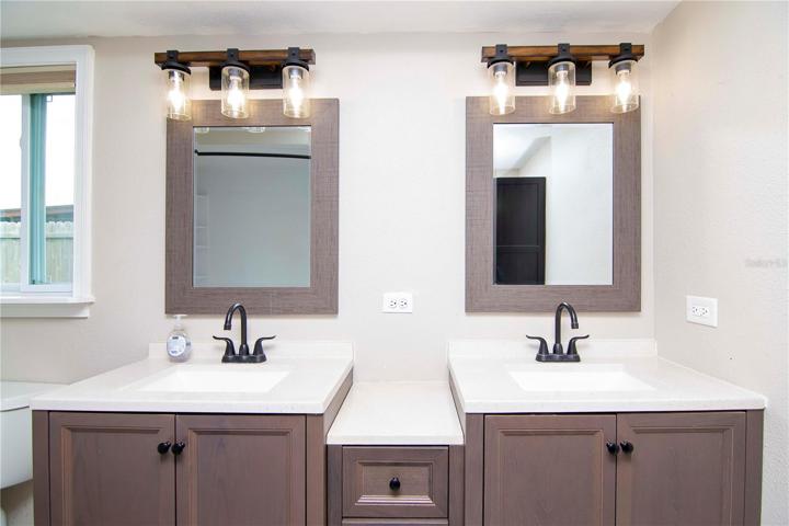 Master Bathroom with dual vanity sinks and shower/tub combo