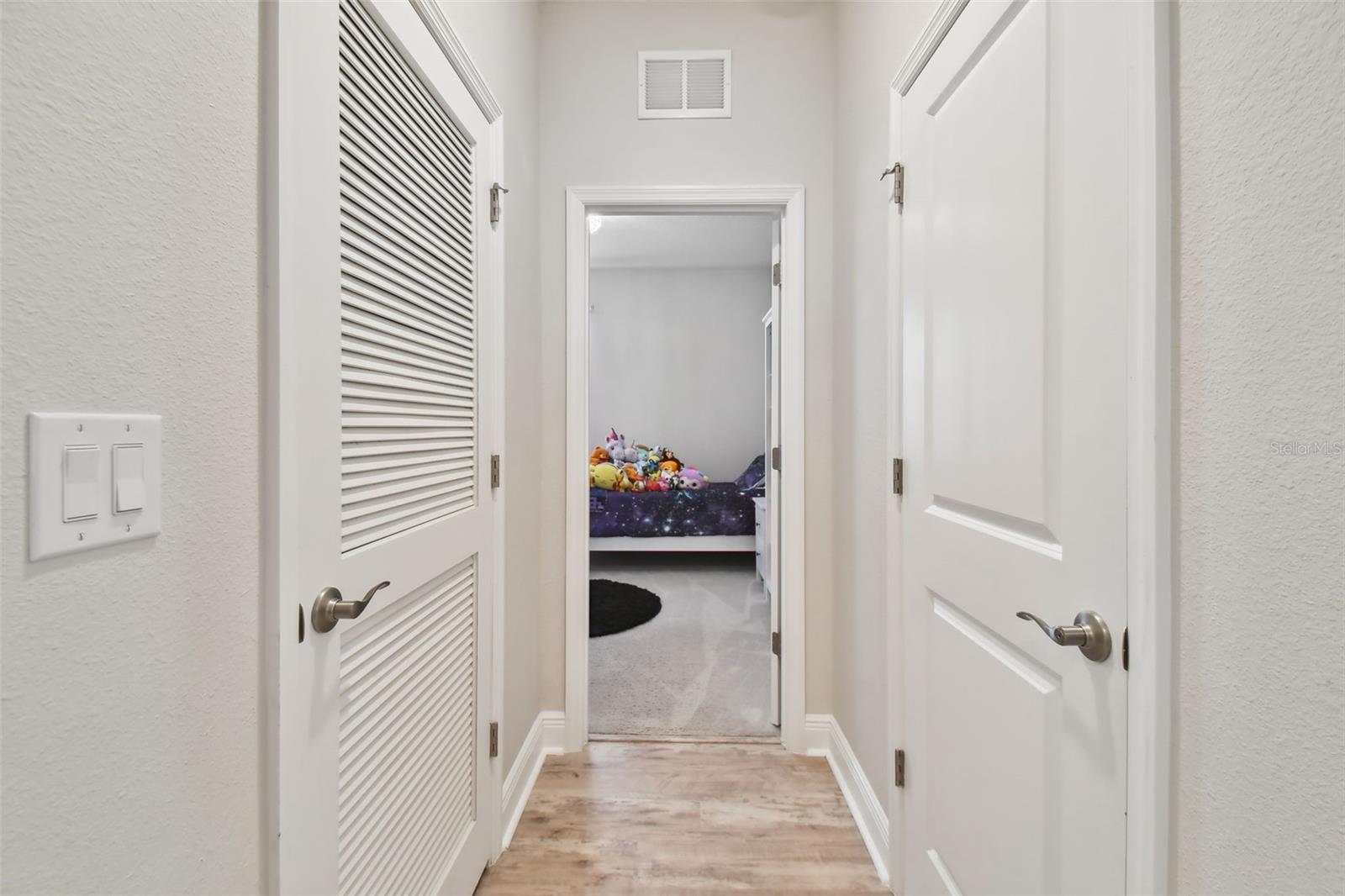 Continuing from the foyer, on the left, is the third secondary bedroom. This 3-way split plan affords maximum privacy.