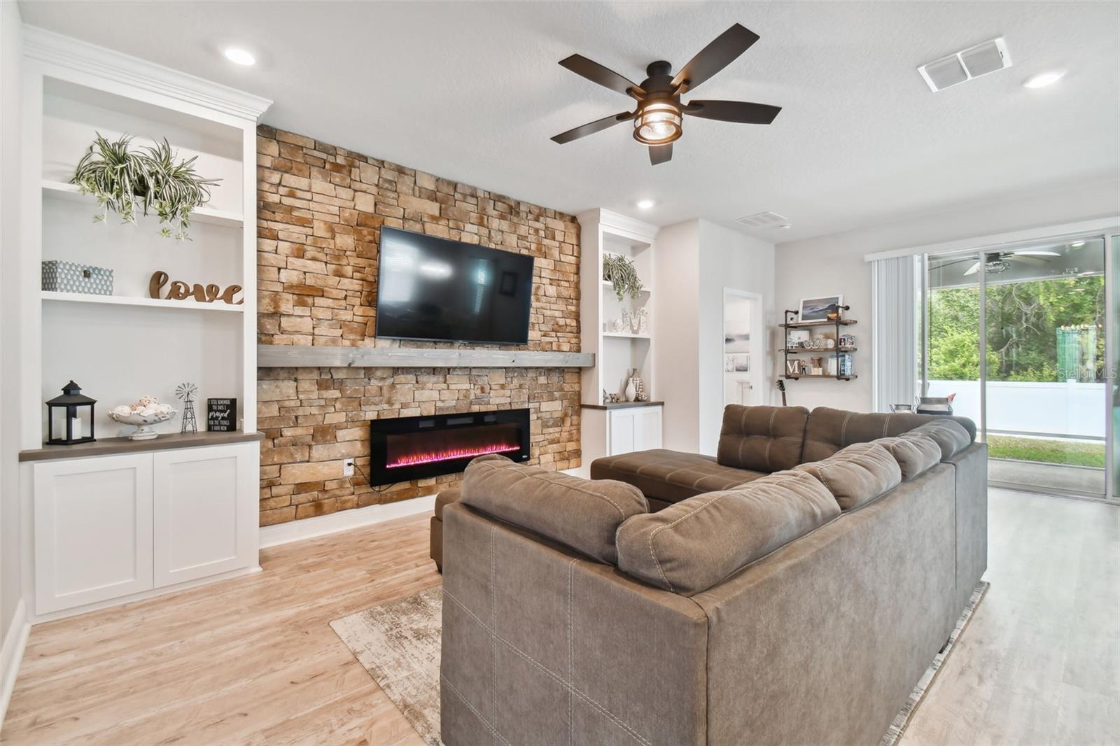 Impressive custom built-in bookshelves and decorator-stone wall, accented by the large custom mantle. Enjoy your built-in electric fireplace for both warmth and beauty.