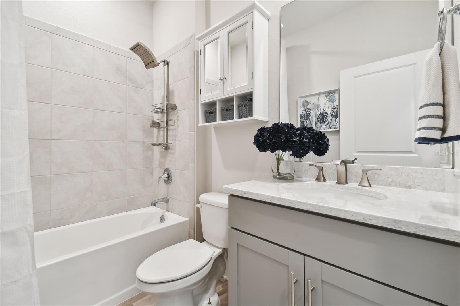 Full shared bath for the front two secondary bedrooms. Tub/shower combo. Large vanity with quartz counter.
