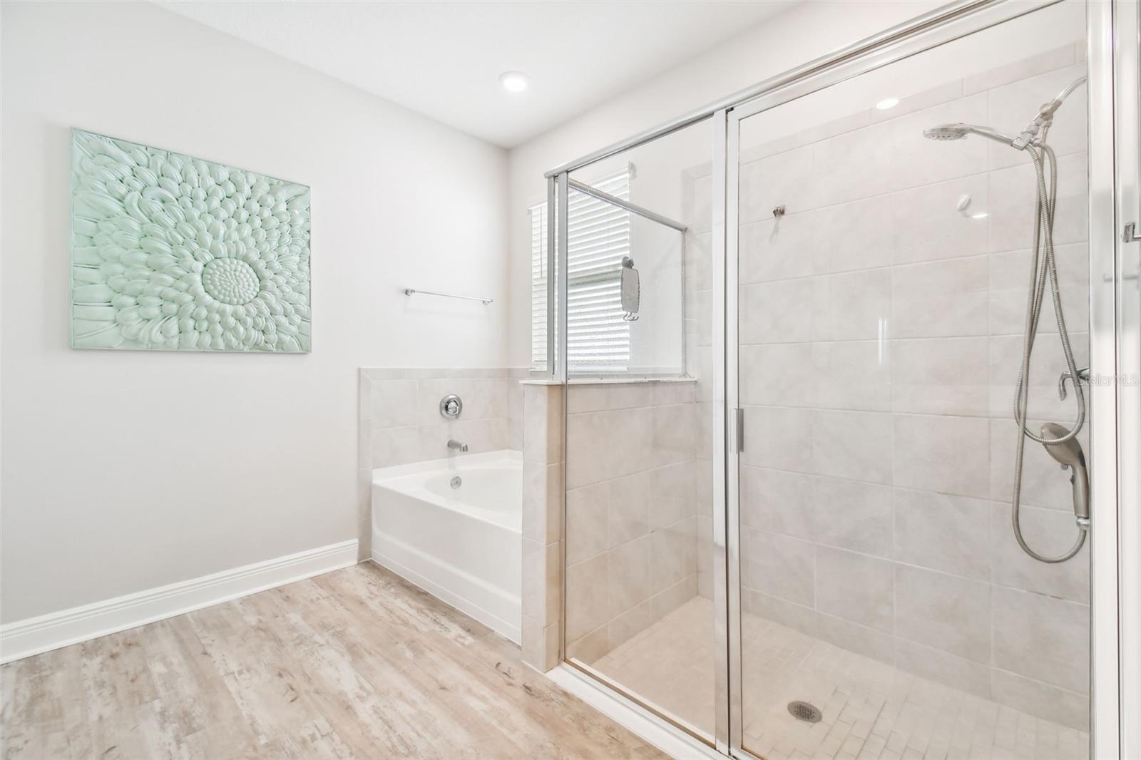 Separate soaking tub and shower. Designer fixtures and tile.