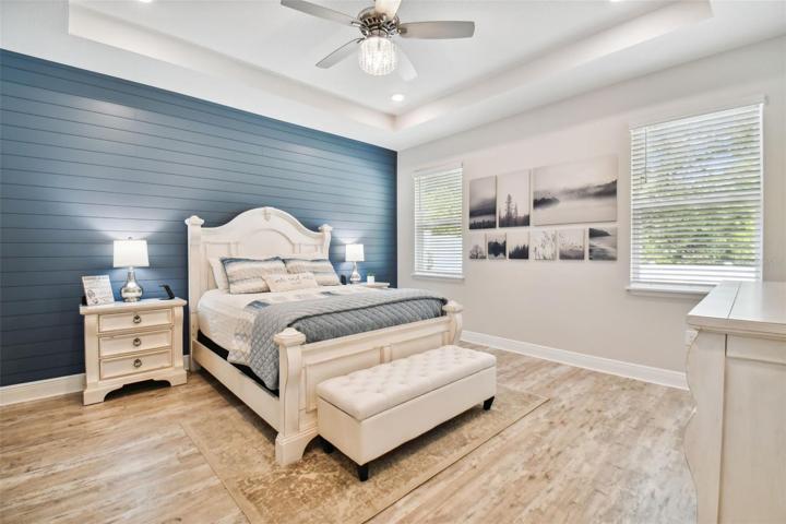 Serene master suite. Decorator custom shiplap accent wall. Tray ceiling and recessed lighting. Luxury vinyl. 5 1/4" baseboards throughout the home!