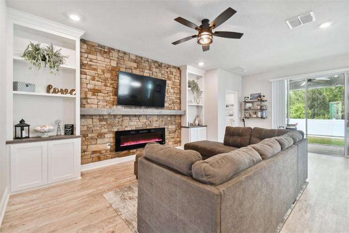 Impressive custom built-in bookshelves and decorator-stone wall, accented by the large custom mantle. Enjoy your built-in electric fireplace for both warmth and beauty.