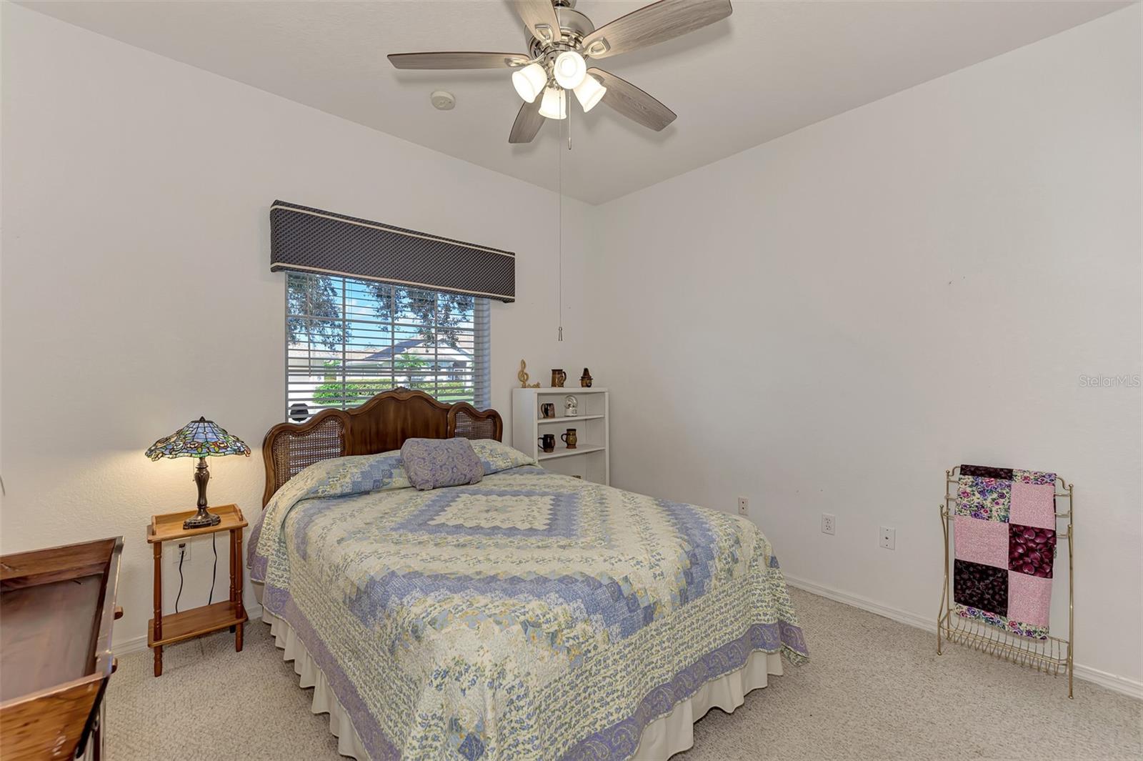 Guest Bedroom with High Ceilings and Plant Ledge