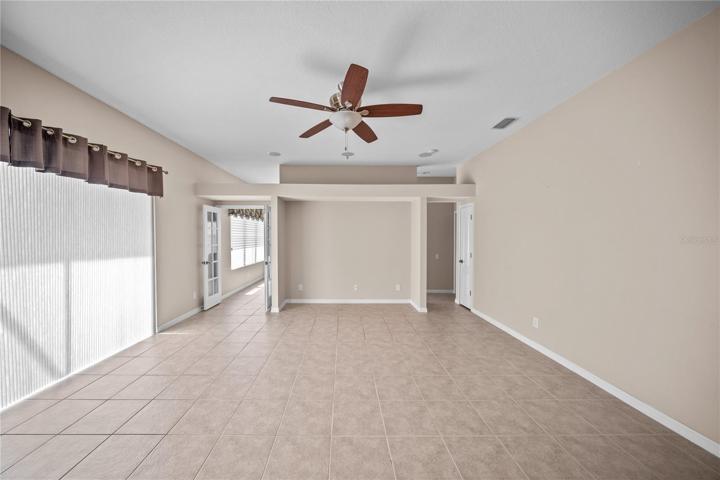 ANOTHER VIEW OF FAMILY ROOM CONNECTING TO THE OFFICE THROUGH THE DOUBLE DOOR.