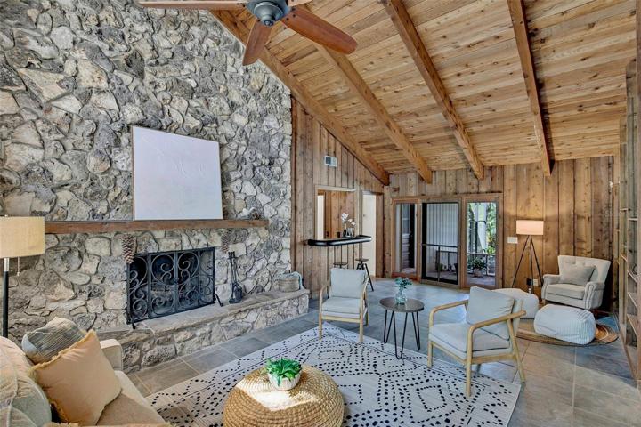 Family room with statement making floor to ceiling stone fireplace