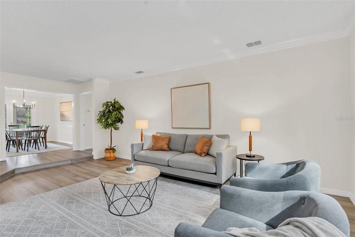 Living room with crown molding, new LVP flooring & new paint