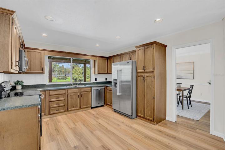The Kitchen centered between the Dining and Family room, is the heart of the home.