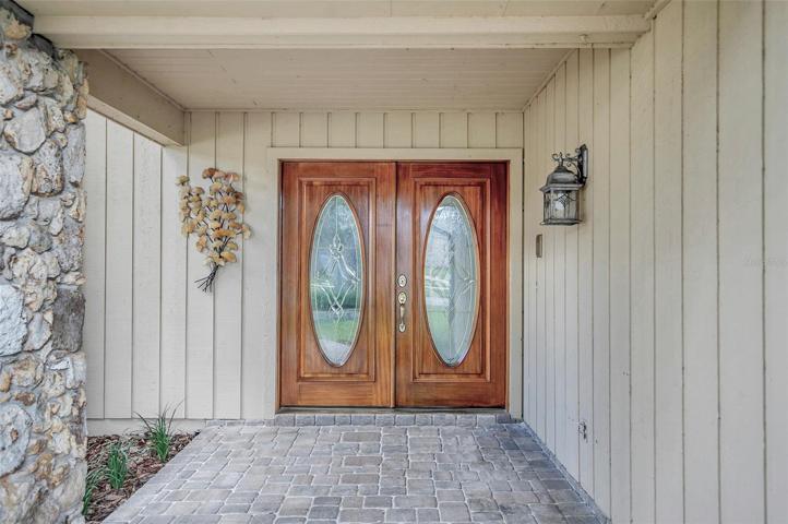 Covered brick paver Front Porch with double door entrance