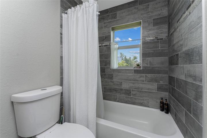 Pretty tiled walls in the tub/shower area.