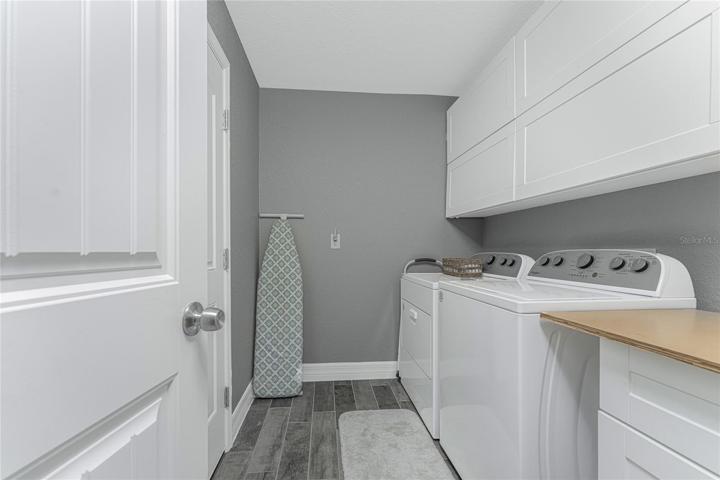 inside laundry room has additional built in cabinetry - you won't get this with a brand new house!