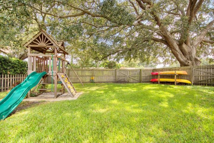Safely fenced backyard with playground set & room for grown up toys too~