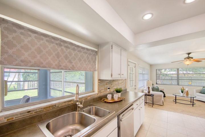 Updated kitchen with raised tray ceiling opens to family room~