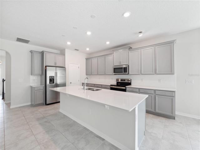 Open Kitchen with Breakfast Bar and Spacious Counters